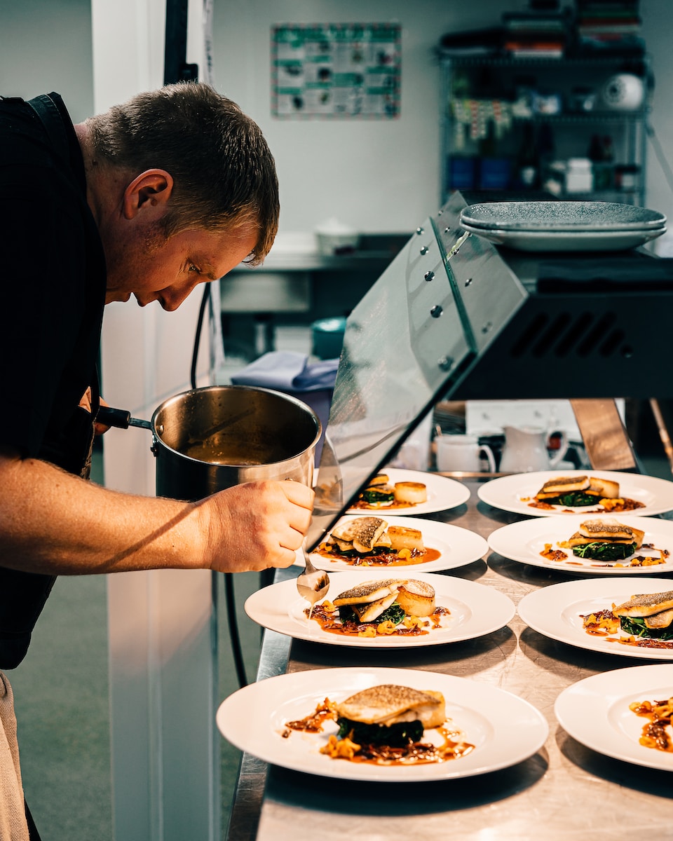 Photo by Sebastian Coman Photography man in black t-shirt holding stainless steel bowl